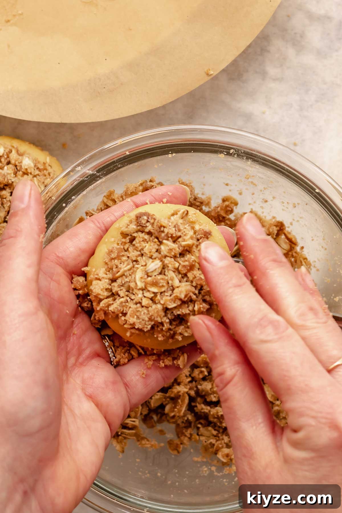 Cinnamon Swirl Coffee Cake Cookies: Soft Baked Recipe 16 Hands push crumb topping onto the top of the cookie.
