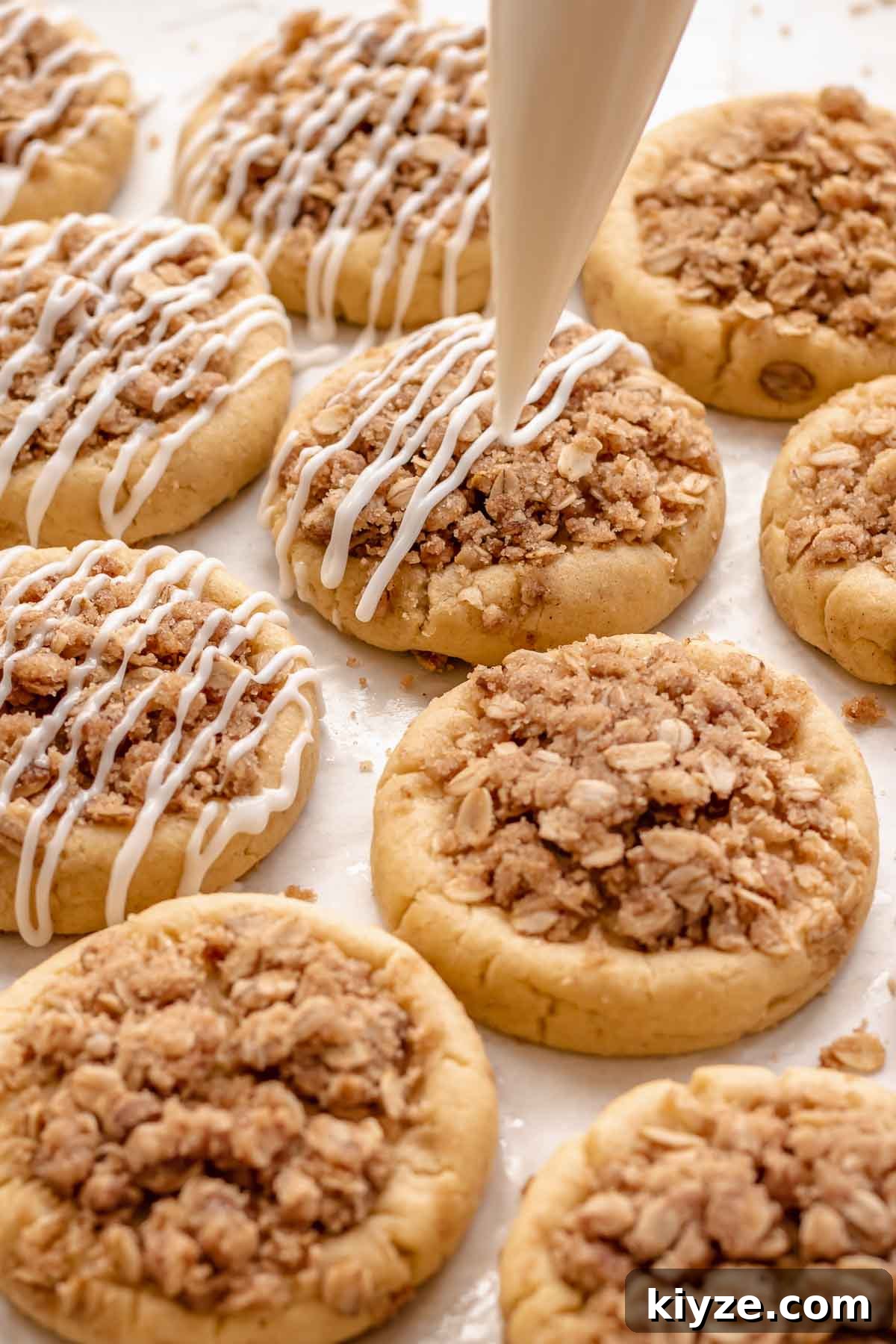 Cinnamon Swirl Coffee Cake Cookies: Soft Baked Recipe 19 A piping bag adds icing onto cookies.