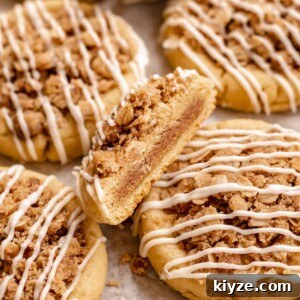 Cinnamon Swirl Coffee Cake Cookies: Soft Baked Recipe 25 Coffee cake cookies. One is cut in half to show the center.