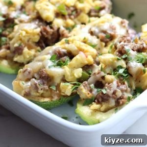 Zucchini Breakfast Boats filled with sausage, scrambled eggs and pepper jack cheese. | low carb, gluten-free, keto, thm | lowcarbmaven.com
