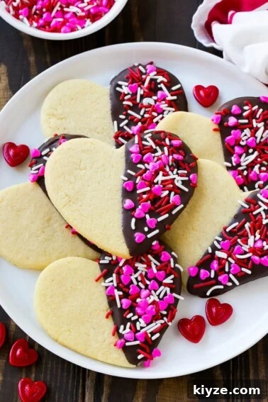 No-Bake Avalanche Cookies Recipe — Quick No-Oven Treat 6 Heart cookies dipped in dark chocolate and decorated with Valentine's Day sprinkles.
