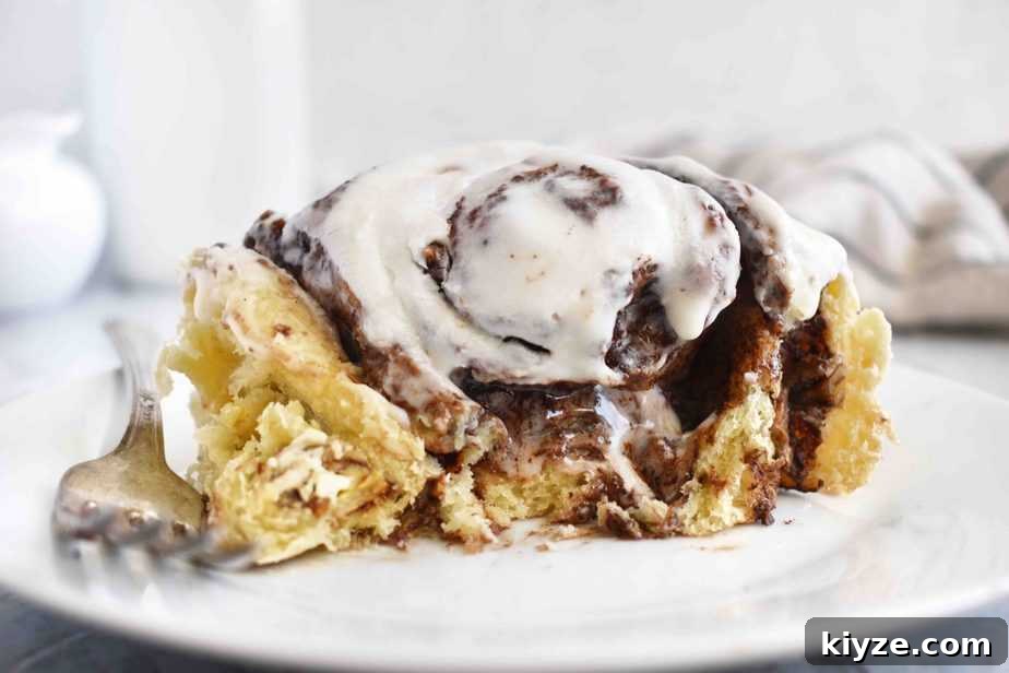 Chocolate Pecan Cinnamon Rolls — Video Recipe Guide 2 half eaten chocolate pecan cinnamon roll on plate