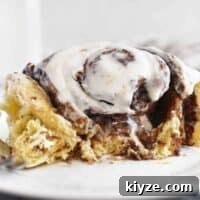 half eaten chocolate pecan cinnamon roll on plate