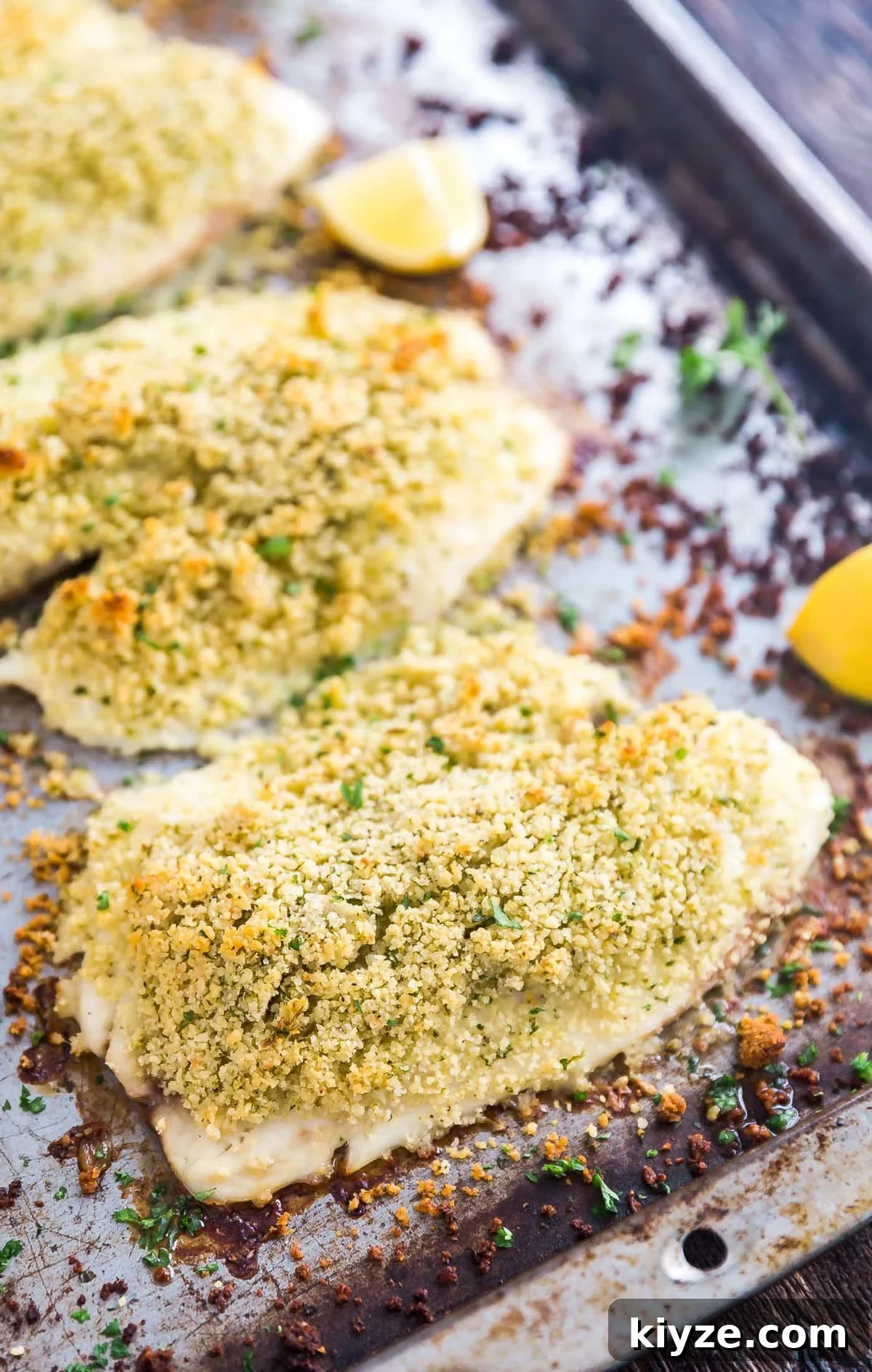 Crispy Parmesan-Crusted Fish Fillets Recipe 2 A close up of parmesan crusted fish on a sheet pan.