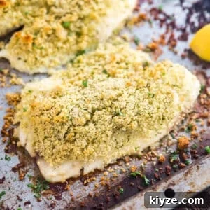 Crispy Parmesan-Crusted Fish Fillets Recipe 14 A close up of parmesan crusted fish on a sheet pan.