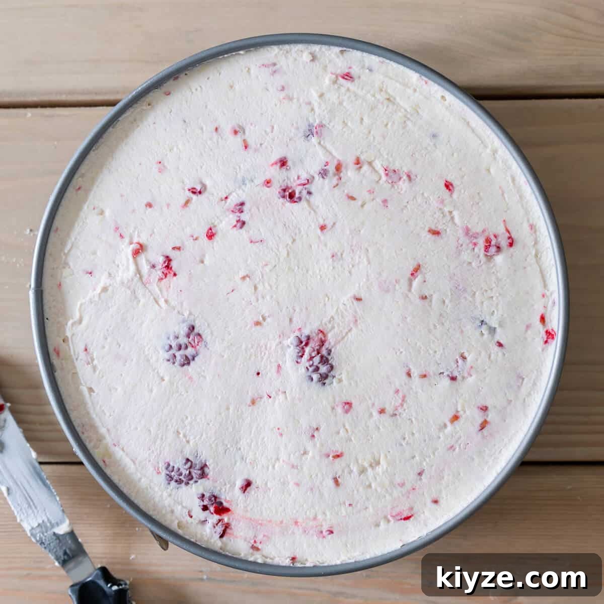 No-Bake Raspberry and White Chocolate Cheesecake Recipe 7 round baking tin raspberry white chocolate cheesecake filling inside.
