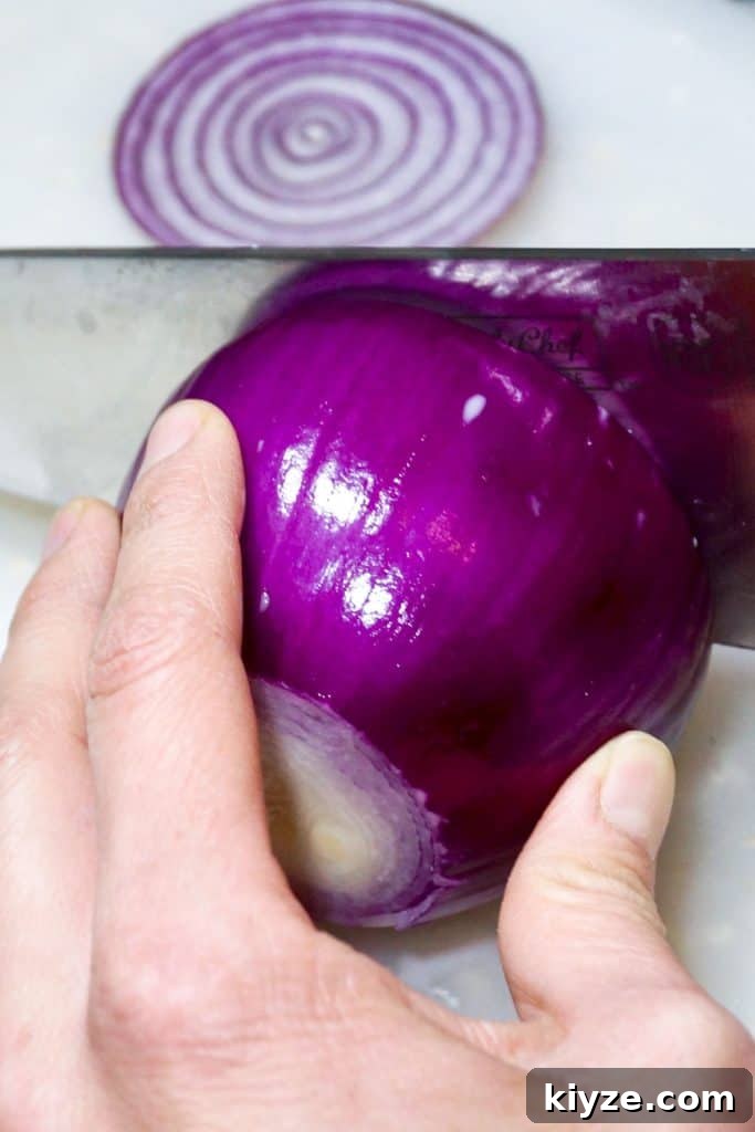 DIY Natural Cough Syrup Recipe for Fast Relief 3 Slicing a red onion for homemade cough syrup