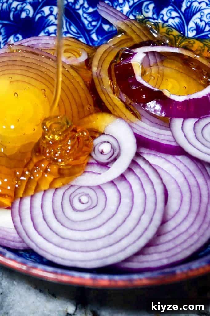 DIY Natural Cough Syrup Recipe for Fast Relief 5 Pouring honey over onions for homemade cough syrup