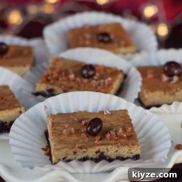 eggnog cheesecake bars on paper holders, on a white platter