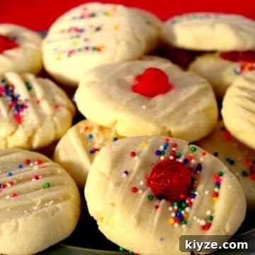 4 ingredient whipped shortbread piled on a plate with red background