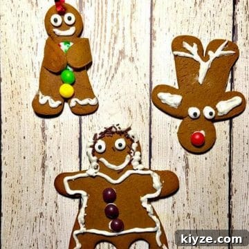 3 gingerbread cookies (a reindeer, dancing gingerbread girl and a gingerbread man) on a white faux wooden surface