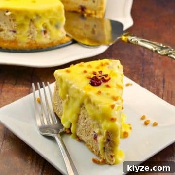 cranberry bread pudding cheesecake on a white plate with a fork and remainder of cheesecake in background