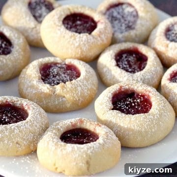 raspberry jam cookies on a white plate