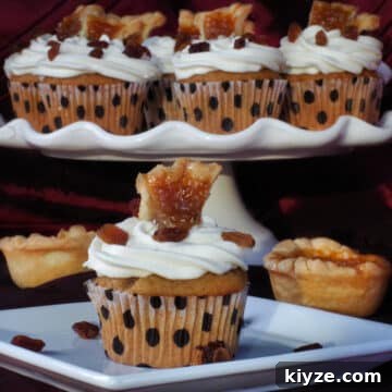 butter tart cupcake on a white plate, with platter of butter tart cupcakes in the background
