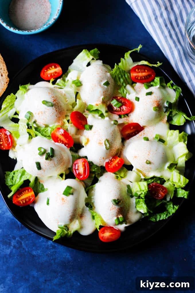 Polish Deviled Eggs with Classic Mayonnaise Filling 3 Eggs Mayonnaise on a serving plate garnished with tomatoes and green onions