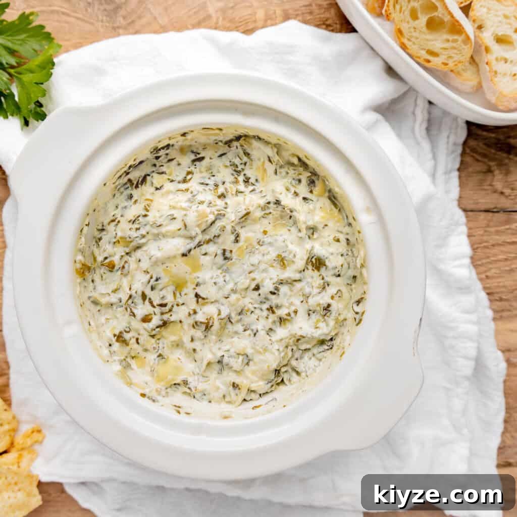Crispy Garlic Crostini with Olive Oil and Herbs 17 Spinach artichoke dip with slices of bread.