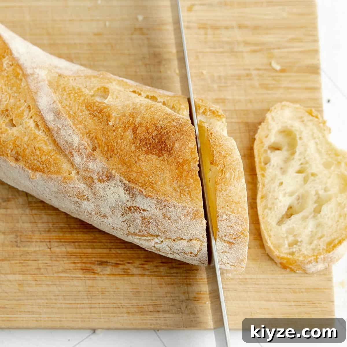 Crispy Garlic Crostini with Olive Oil and Herbs 4 Slicing a baguette.