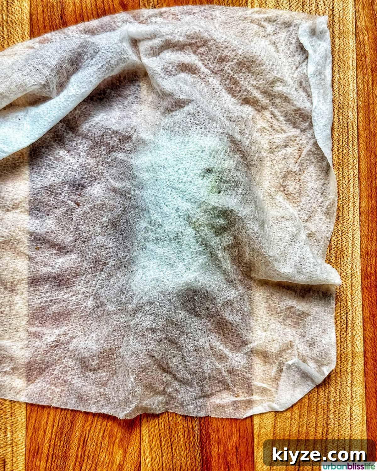 Crispy Rice Paper Dumplings with Savory Filling and Dipping Sauce 13 damp paper towel over a rice paper dumpling on cutting board.