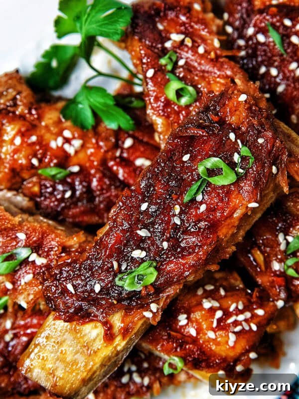 Crispy Rice Paper Dumplings with Savory Filling and Dipping Sauce 22 Instant Pot Asian Sticky Pork Ribs on a white plate.