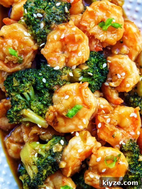 Crispy Rice Paper Dumplings with Savory Filling and Dipping Sauce 23 shrimp and broccoli str fry on a white plate.