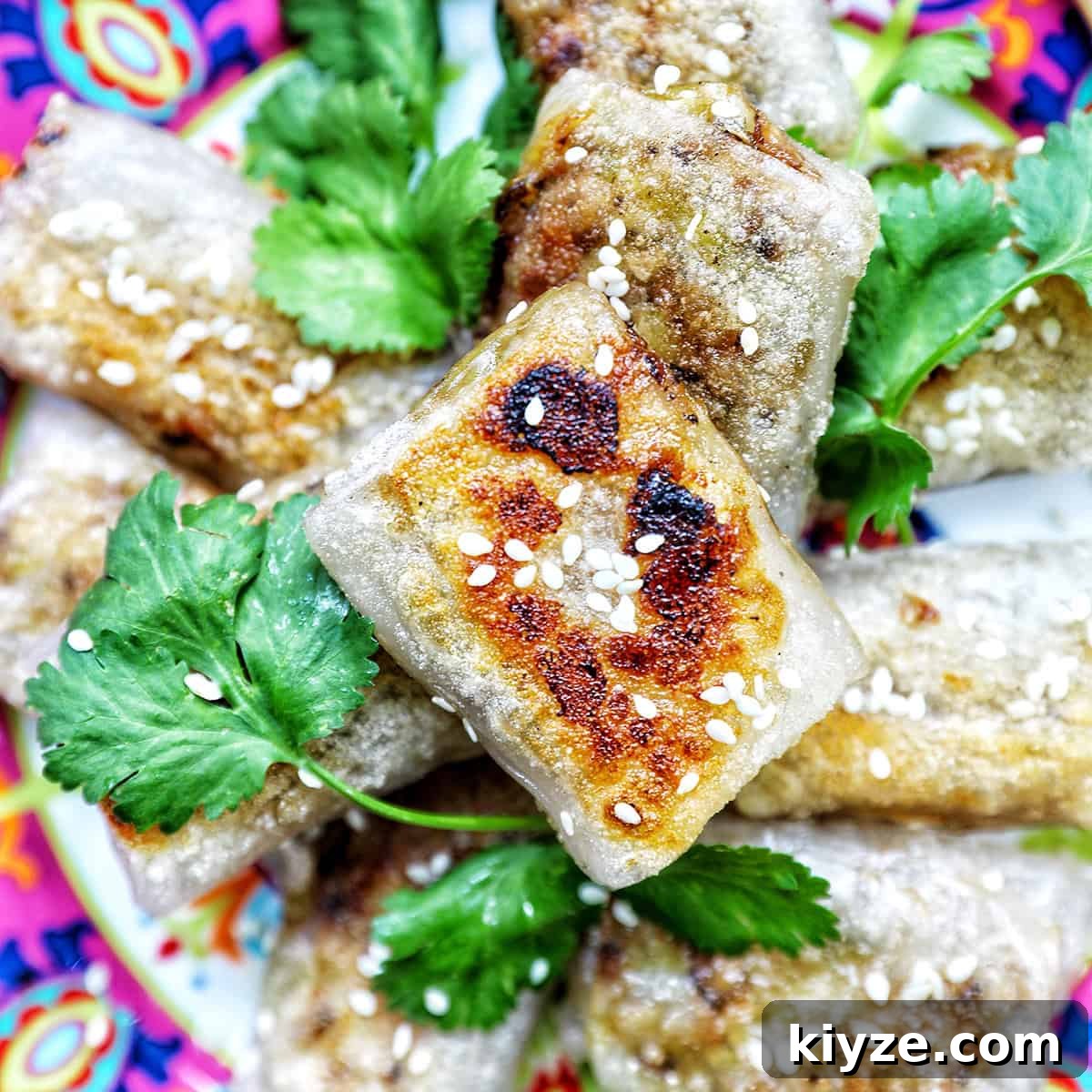 Crispy Rice Paper Dumplings with Savory Filling and Dipping Sauce 25 crispy rice paper dumplings on a plate with herbs.
