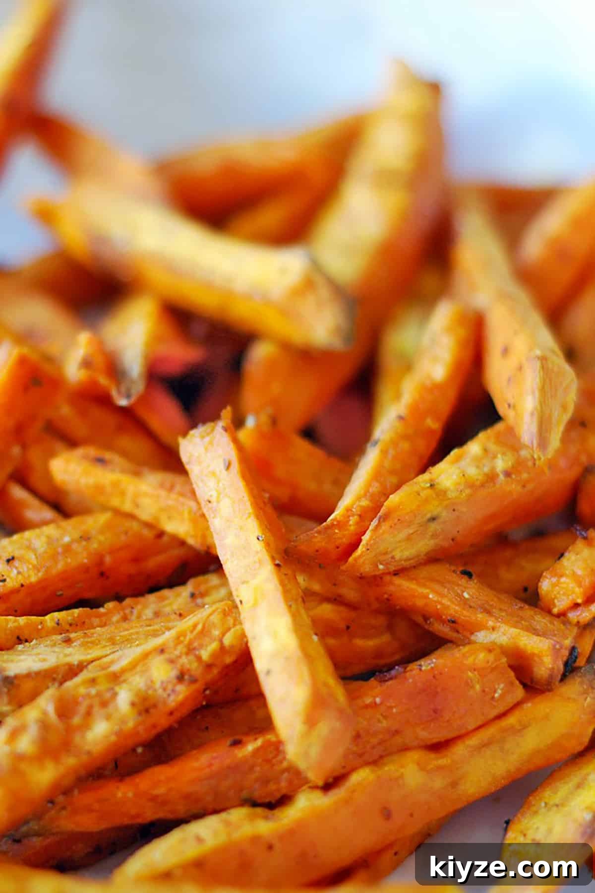 Crispy Sweet Potato Fries: Oven or Air Fryer Method 3 A portrait photo of oven-baked or air fryer cooked sweet potato fries.