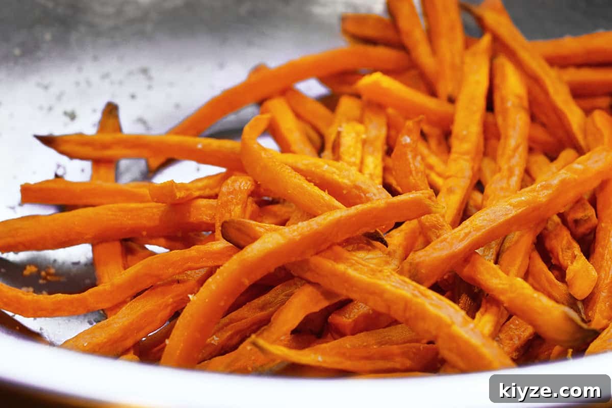 Crispy Sweet Potato Fries: Oven or Air Fryer Method 8 A silver bowl filled with crispy oven fried sweet potato fries.