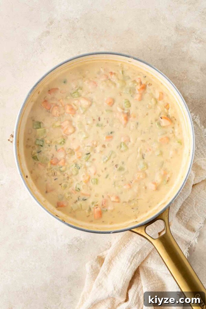Dairy-Free Chicken Pot Pie Recipe: Creamy, Comforting Pie 6 The creamy pie filling sauce in a frying pan.