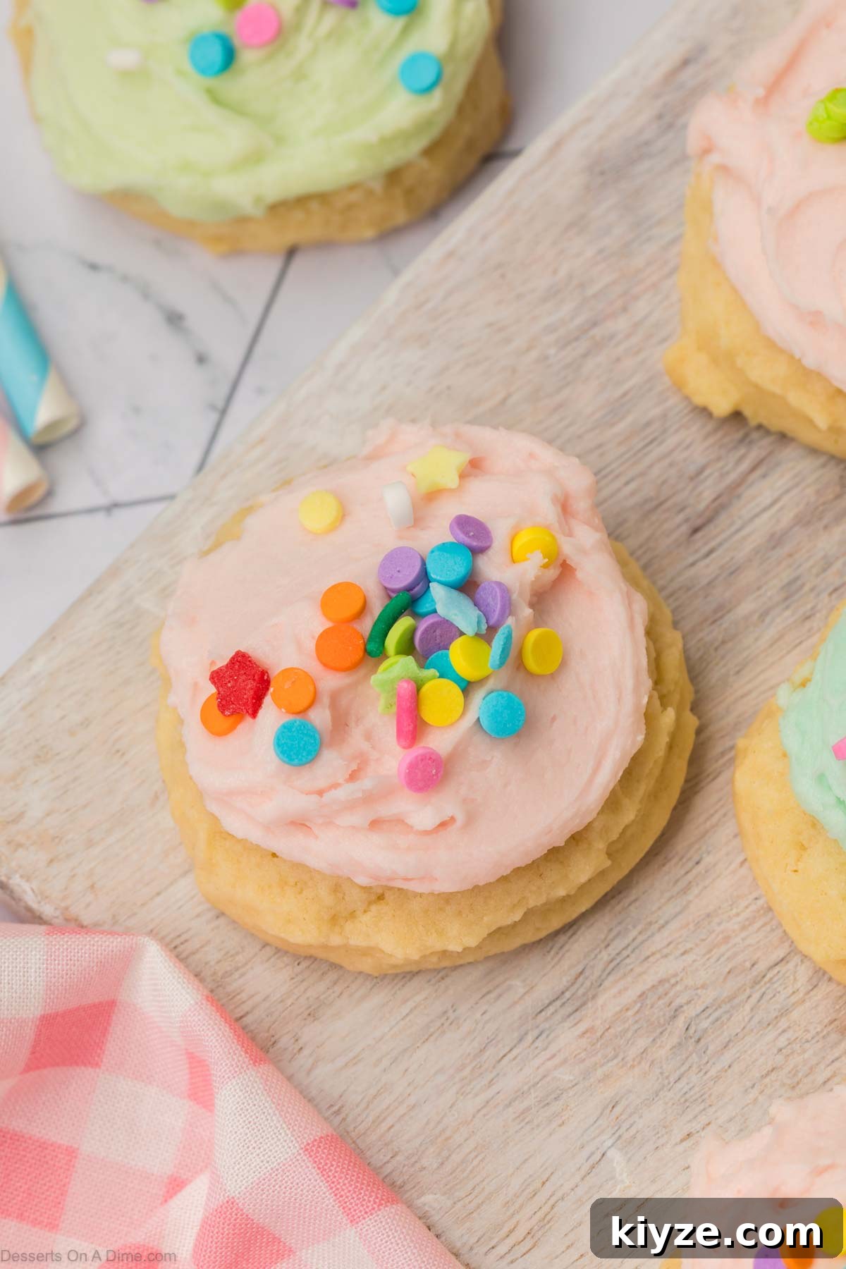 Sour Cream Sugar Cookies Recipe for Soft, Tender Cookies 2 Sour Cream Sugar Cookies with frosting and sprinkles.