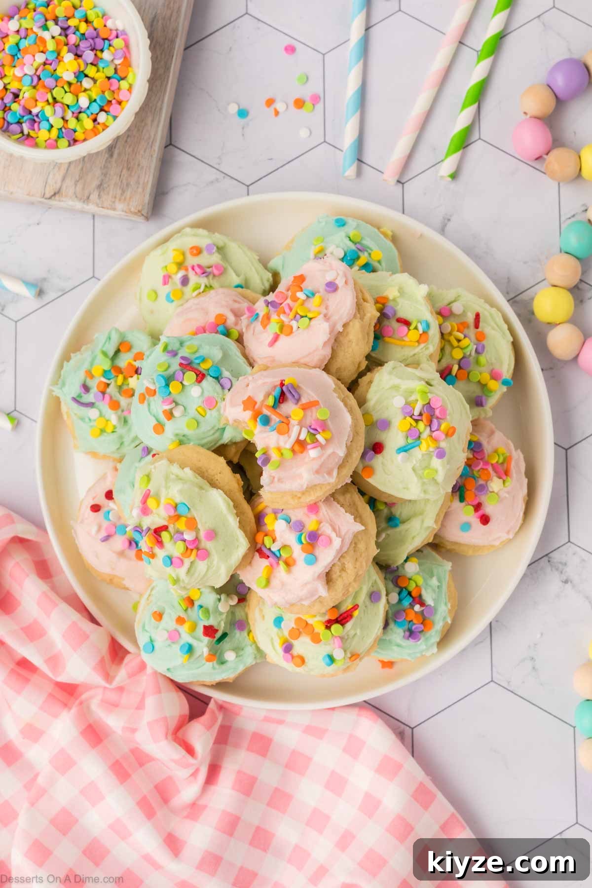 Sour Cream Sugar Cookies Recipe for Soft, Tender Cookies 16 Frosted sugar cookies on a platter.