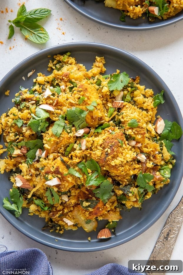 cauliflower rice stir fry overhead shot of a blue plate with Indian paleo cauliflower rice stir-fry with chicken