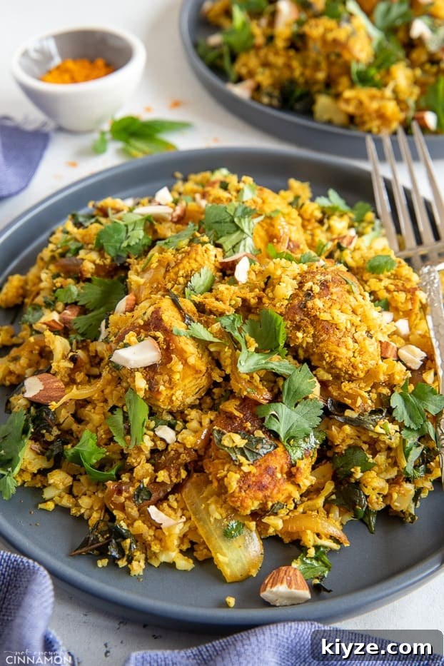 cauliflower rice stir fry side view close-up of a plate of Indian cauliflower rice stir fry chicken biryani style