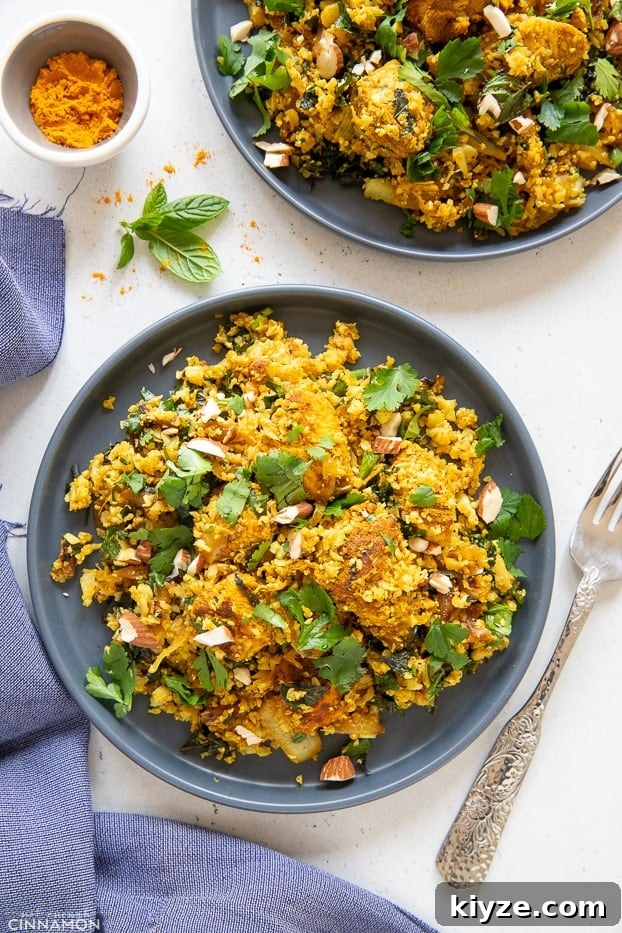 cauliflower rice stir fry overhead shot of two plates with paleo chicken biryani cauliflower rice stir fry topped with chopped herbs