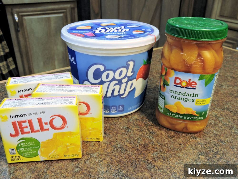 Citrus Jello Fluff Salad with Lemon and Orange Zest 3 Jello, Cool Whip and mandarin oranges displayed on countertop