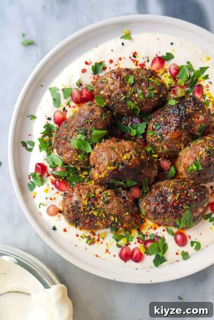 Crispy Dukkah Potatoes with Aioli & Pink Tahini Drizzle 16 Lamb kofta with parsley, pomegranate seeds and dukkah on a white plate with yogurt tahini sauce, with a bowl of yogurt tahini sauce on the side.