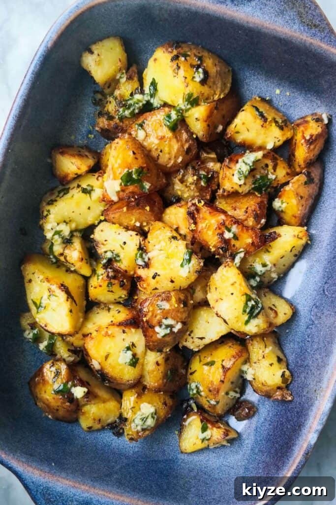 Crispy Dukkah Potatoes with Aioli & Pink Tahini Drizzle 20 Garlic butter potatoes in a small blue oven dish.
