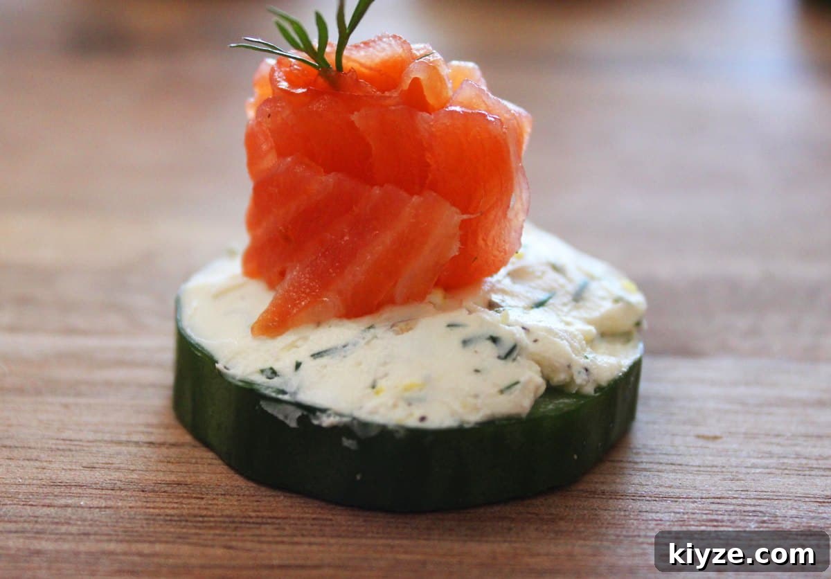 Cucumber Salmon Bites: Fresh Appetizer Recipe for Parties 5 up close shot of salmon bite on a timber board.