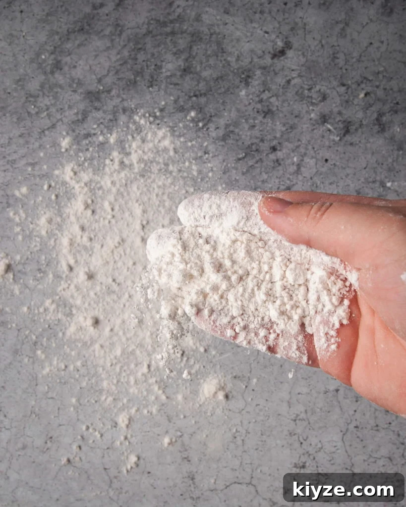 Flouring a clean surface to shape tortillas on.