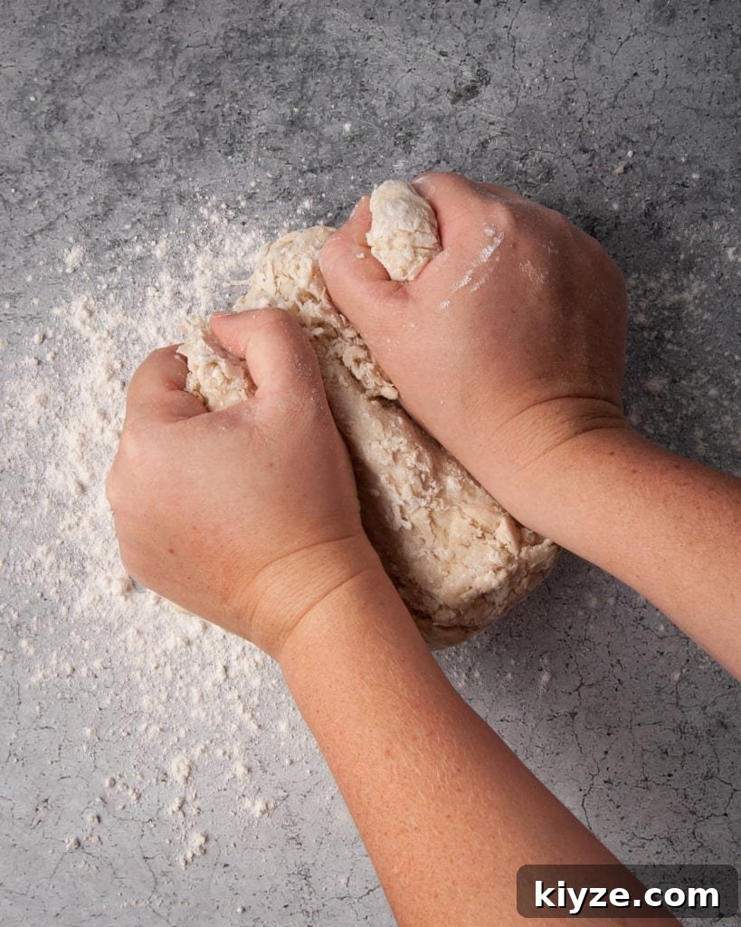 Kneading tortilla dough on a floured surface.