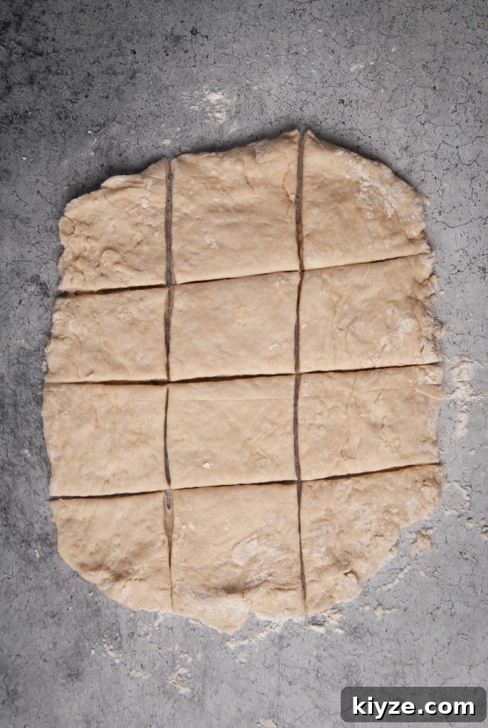 Cutting dough into 12 roughly equal-sized pieces.