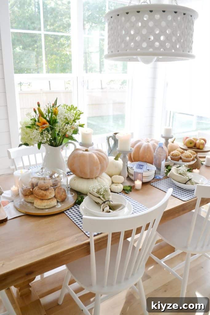 Fall Tablescape Ideas You Can Recreate at Home 8 a pumpkin tablescape for fall entertaining with white chairs around a table