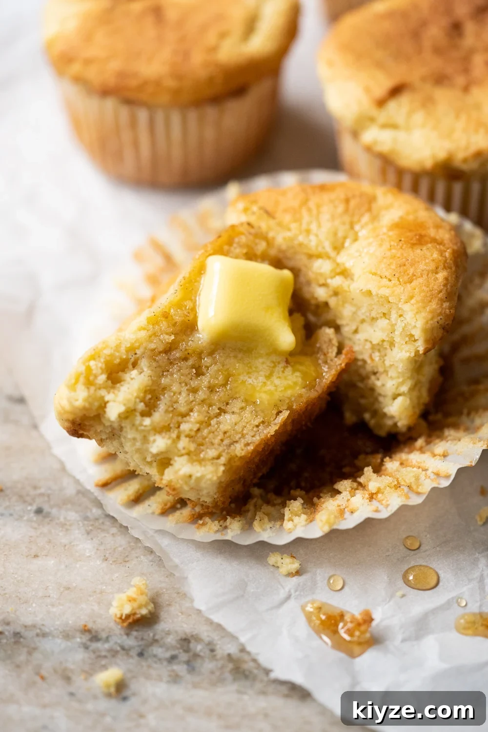Keto Cornbread Muffins (1g Net Carb Each) 2 A halved keto cornbread muffin with a pat of butter melting through