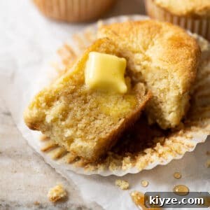 Keto Cornbread Muffins (1g Net Carb Each) 6 A halved keto cornbread muffin with a pat of butter melting through