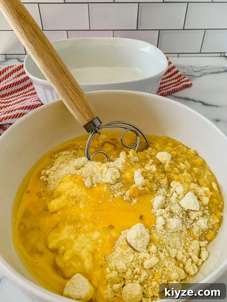 Jiffy Cornbread with Creamed Corn Casserole Recipe 6 mixing all the ingredients in a large bowl using a whisk.