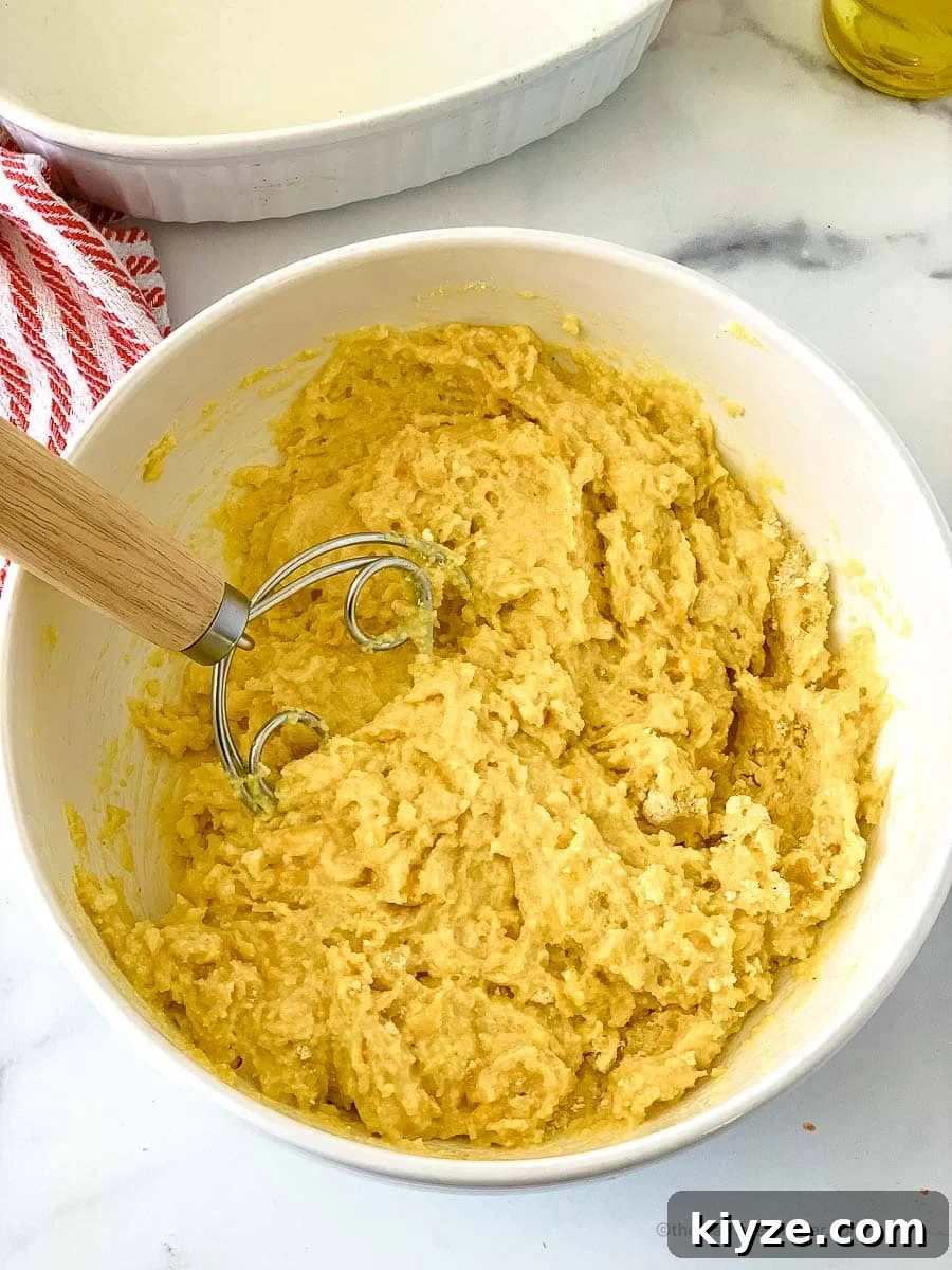 Jiffy Cornbread with Creamed Corn Casserole Recipe 7 mixed ingredients in a large bowl using a whisk.