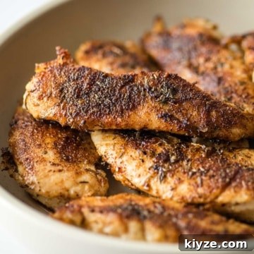 Cajun Blackened Chicken Tenders with Zesty Dipping Sauce 16 Blackened chicken tenders in a white bowl on a table.