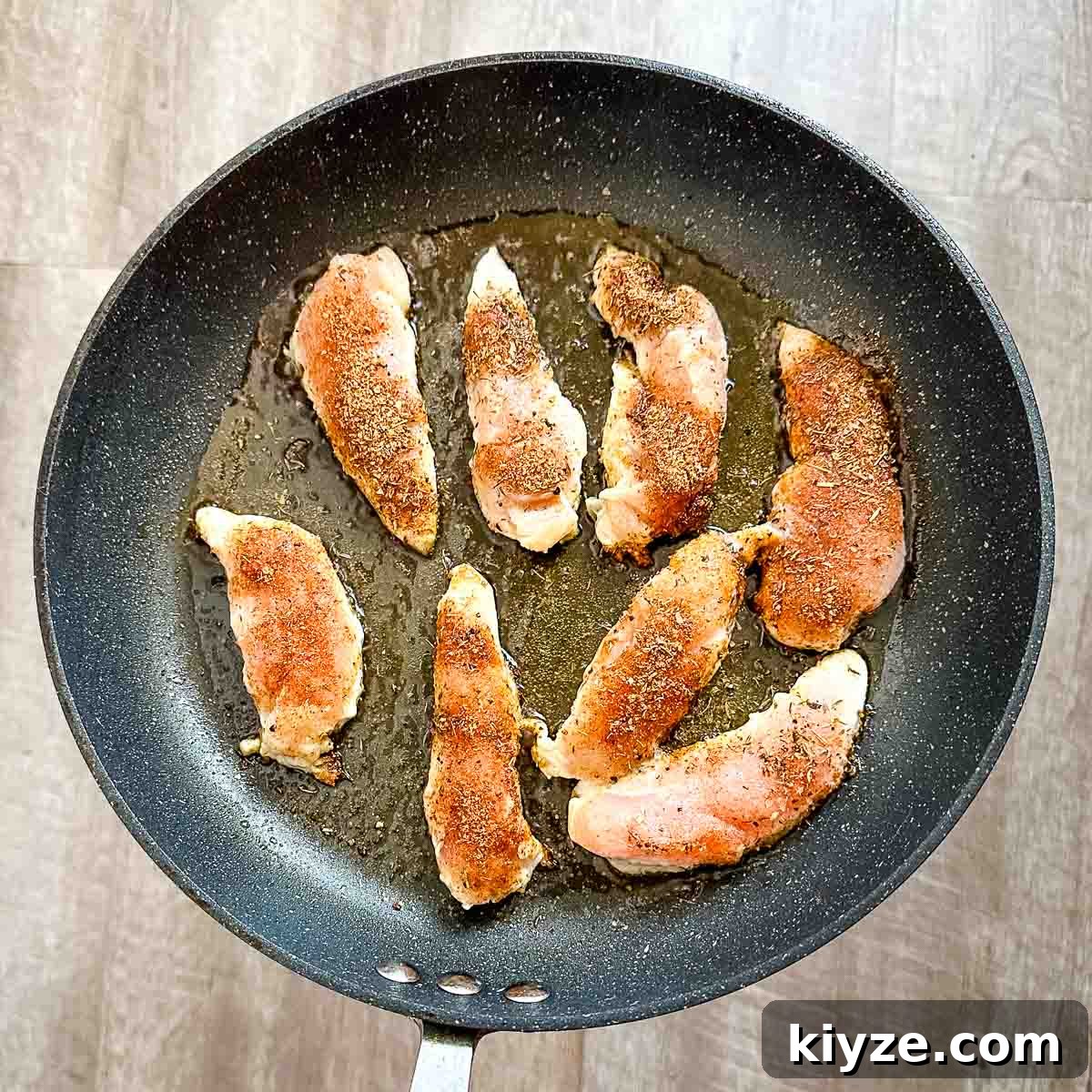 Cajun Blackened Chicken Tenders with Zesty Dipping Sauce 7 Blackened chicken tenders cooking in a frying pan.