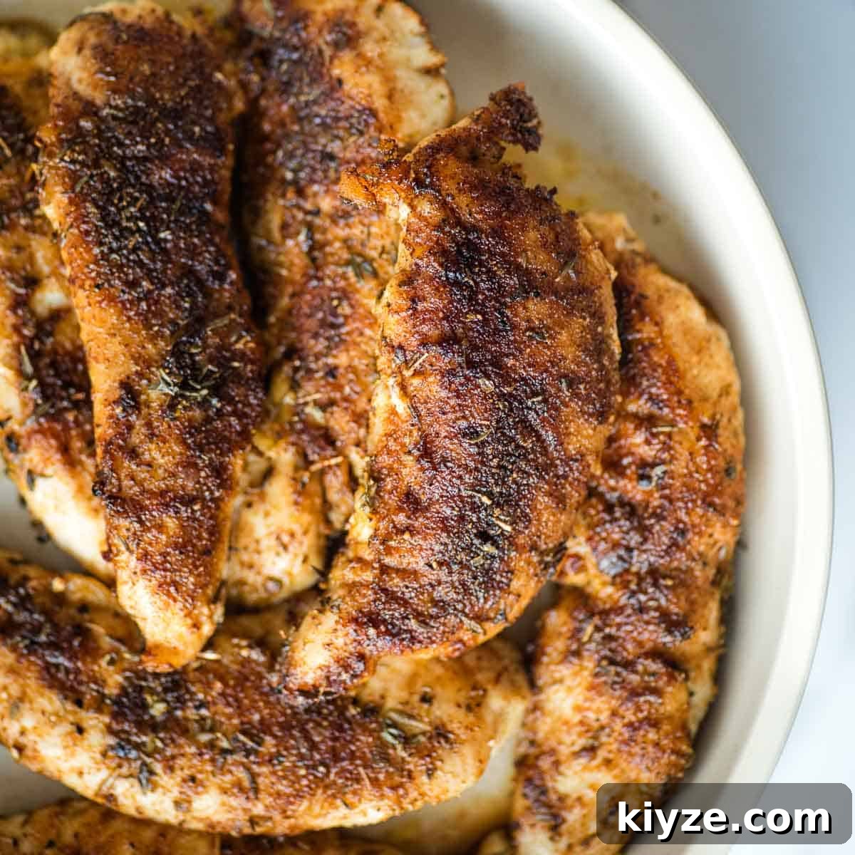 Cajun Blackened Chicken Tenders with Zesty Dipping Sauce 10 Blackened chicken tenders in a white dish.