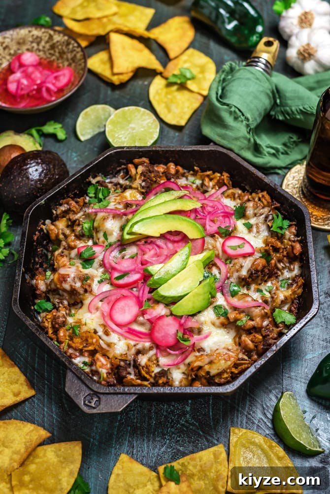 One-Pan Cheesy Enchilada Skillet Recipe 4 Easy Enchilada Skillet, close-up of skillet with melted cheese and pickled onions