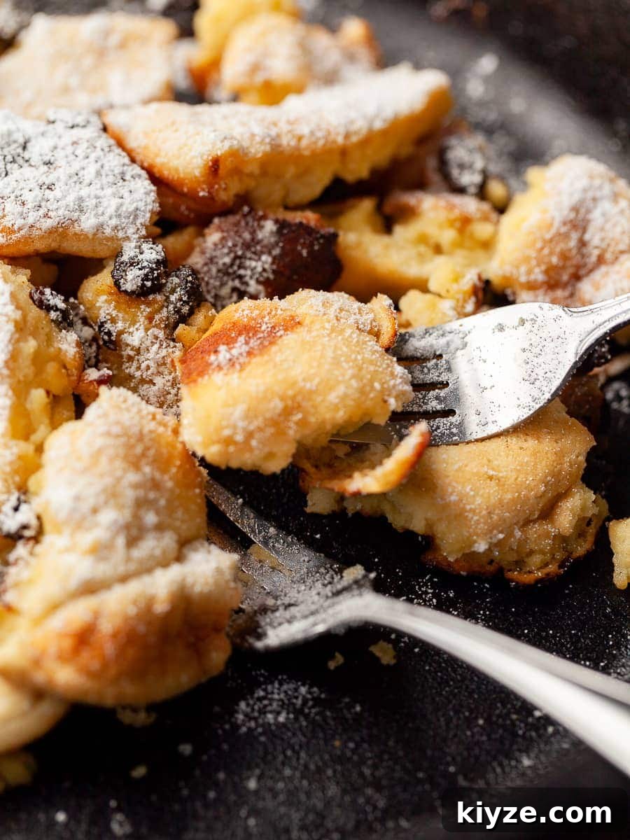 Gluten-Free Kaiserschmarrn Recipe: Fluffy Austrian Pancake Dessert 9 close up of gluten free kaiserschmarrn in a pan with two forks